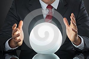 Close-up Of Businessman Hand On Crystal Ball photo