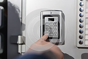 Close up of businessman hand entering security system code