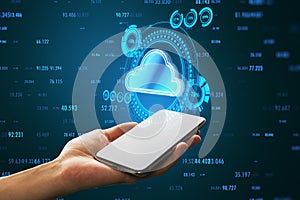 Close up of businessman hand holding cellphone with cloud computing hologram with index on blue background. Connectivity