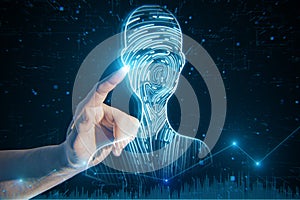 Close up of businessman hand pointing at abstract digital fingerprint man or person silhouette on blurry blue background. Identity