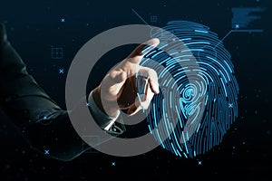 Close up of businessman hand pointing at abstract glowing finger print id hologram on dark background. Fingerprint, biometrics,