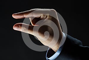 Close up of businessman hand showing small size