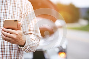 Close up businessman hand using a mobile smart phone call a car