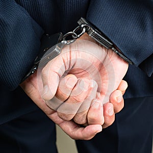 Close-up businessman hands in handcuffs. Businessman bribetaker