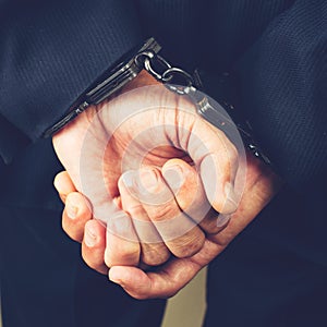 Close-up businessman hands in handcuffs. Businessman bribetaker