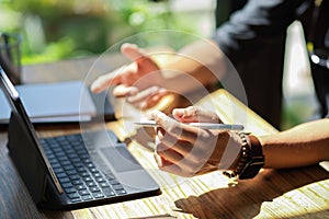 Close-up Businessman hands holding stylus pen and working on tablet