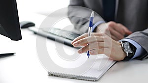 Close up of businessman hands with notepad