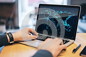 Close up of businessman hands using laptop computer on desktop with glowing binary code map and blurry background. Software and