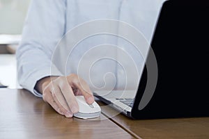 Close up, Businessman hands using mouse and computer laptop, browsing internet information and searching web, working outside