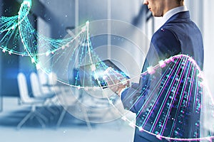 Close up of businessman hands using tablet with glowing binary code DNA helix on blurry office interior background. Human genome