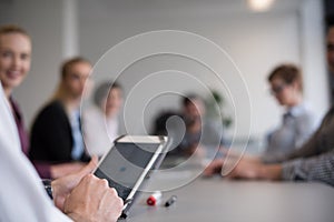 Close up of businessman hands using tablet on meeting