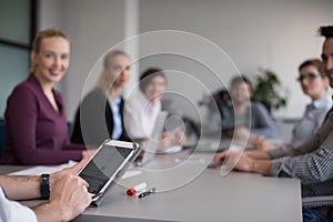 Close up of businessman hands using tablet on meeting