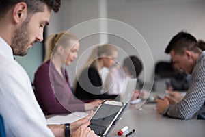 Close up of businessman hands using tablet on meeting