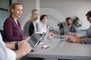 Close up of businessman hands using tablet on meeting