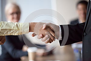 Close up of businessman handshake intern greeting with promotion photo