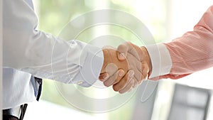 Close up of businessman handshake at office, business cooperation, success in business concept