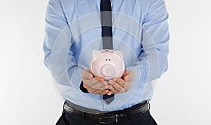 Close up of  businessman holding pig money box