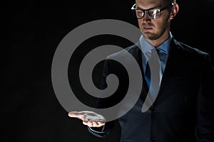 Close up of businessman holding something on hand