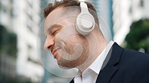 Close up of businessman listen headphone and dancing to relaxing music. Urbane.