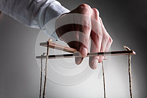 Close-up Of A Businessman Manipulating Marionette