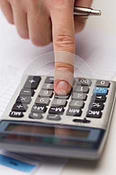 Close up of businessman with papers and calculator