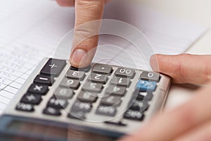 Close up of businessman with papers and calculator