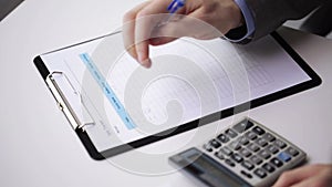 Close up of businessman with papers and calculator