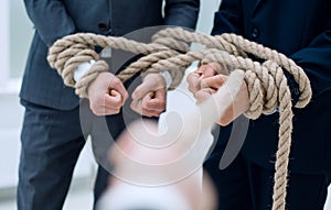 Close up.businessman pulls a business team on a rope