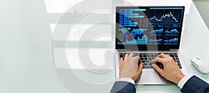 Businessman Analyzing Graph On Laptop