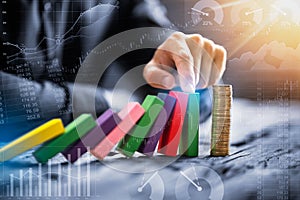 Close-up Of A Businessman's Hand Stopping Falling Blocks