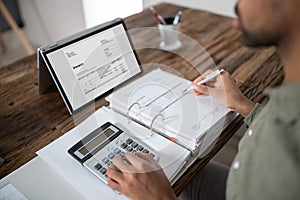 Businessman`s Hands Working On Invoice On Laptop