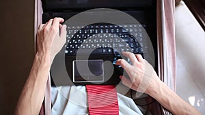 Close-up of businessman`s hands working on a laptop. Top of view of a businessman lying in a hammock. 1920x1080