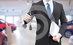 Close up of businessman or salesman giving car key