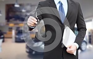 Close up of businessman or salesman giving car key