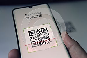 Close-up Of Businessman Scanning. Barcode Using Cell Phone