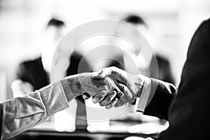 close up. businessman shaking hands with an elderly business lady.