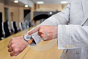 Close-up of a businessman showing his watch