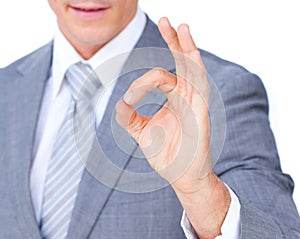 Close-up of a businessman showing OK sign