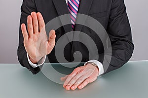 Close up businessman showing stop gesture with hand.