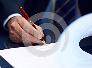 Close up of businessman signing a contract. photo