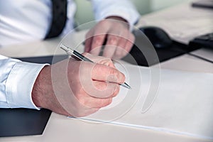 Close up of businessman signing a contract. Business concept