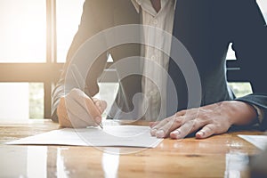 Close-up Of Businessman Signing Contract Paper With Pen, vintage