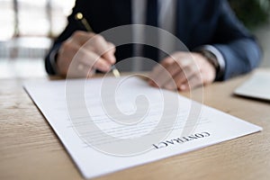 Close up businessman signing contract, putting signature on legal document