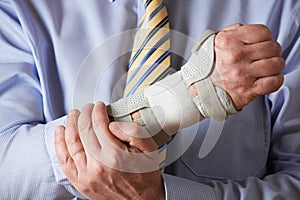 Close Up Of Businessman Suffering With Repetitive Strain Injury photo