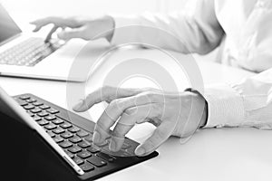 close up of businessman typing keyboard with laptop computer and