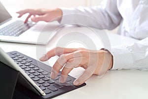 close up of businessman typing keyboard with laptop computer and