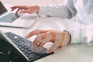 close up of businessman typing keyboard with laptop computer and