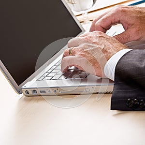 Close up of businessman typing on laptop