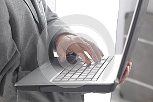 Close up.businessman typing on a laptop keyboard.isolated on white background