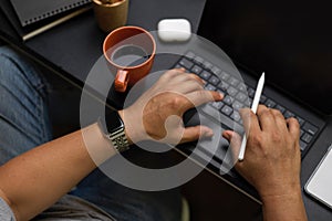 Close up, businessman typing on portable tablet